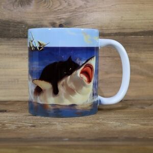 Cat Biting Shark Funny Cat And Shark Humor Coffee Mug. 11 Oz.